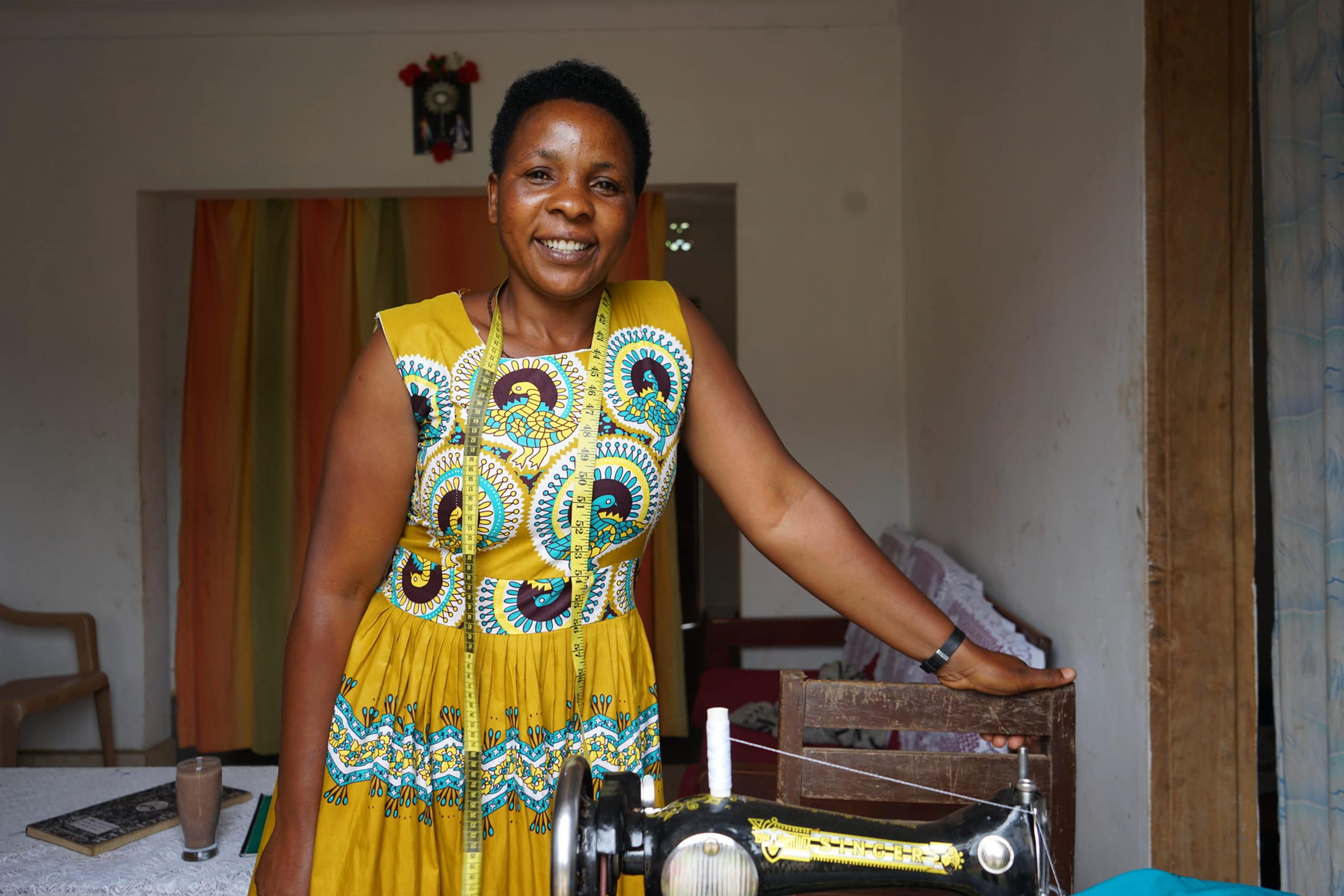Georgina with her sewing machine Portrait of Georgina wearing a yellow dress and leaning on her sewing machine