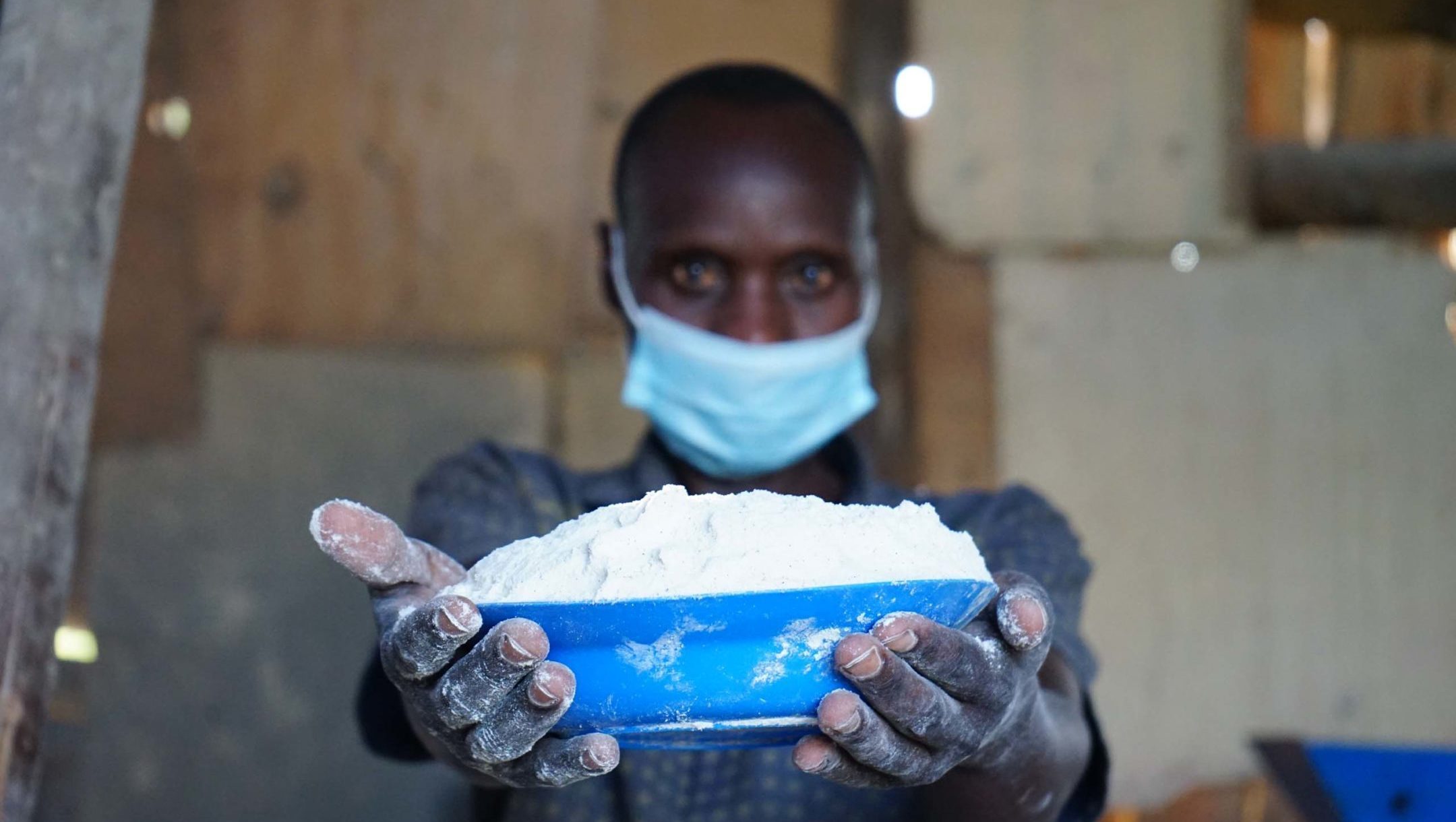 A Photo of Edson showing milled maize flour.