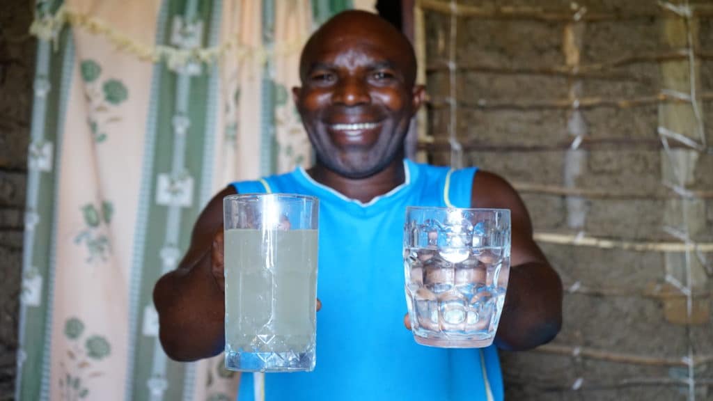 Malaki demonstrates the biosand water filter provided by RTV in his village, Kamina in Kabukanga cluster.