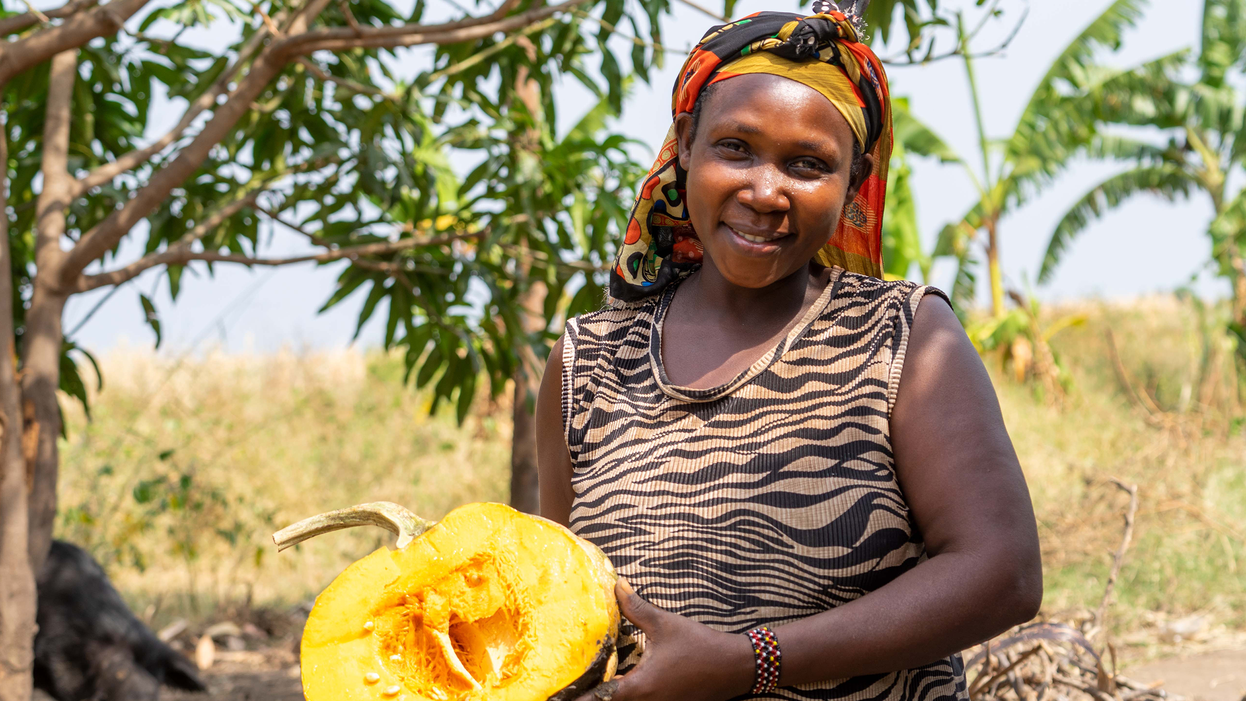 Aisha shows us a pumpkin she is ready to eat in Kabukanga cluster, Kagadi district.