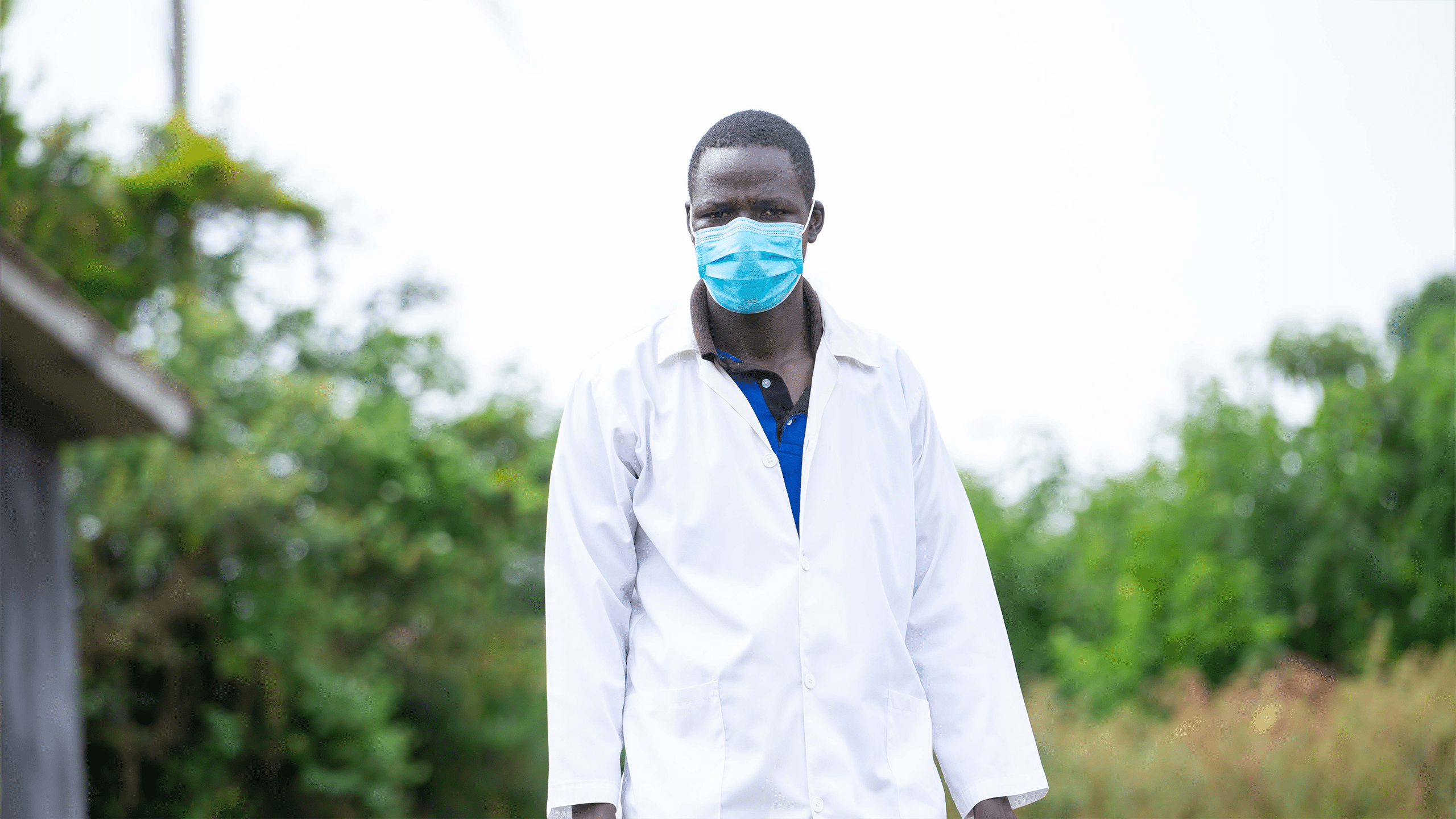 Raimond stands infront of Ndaiga health center II