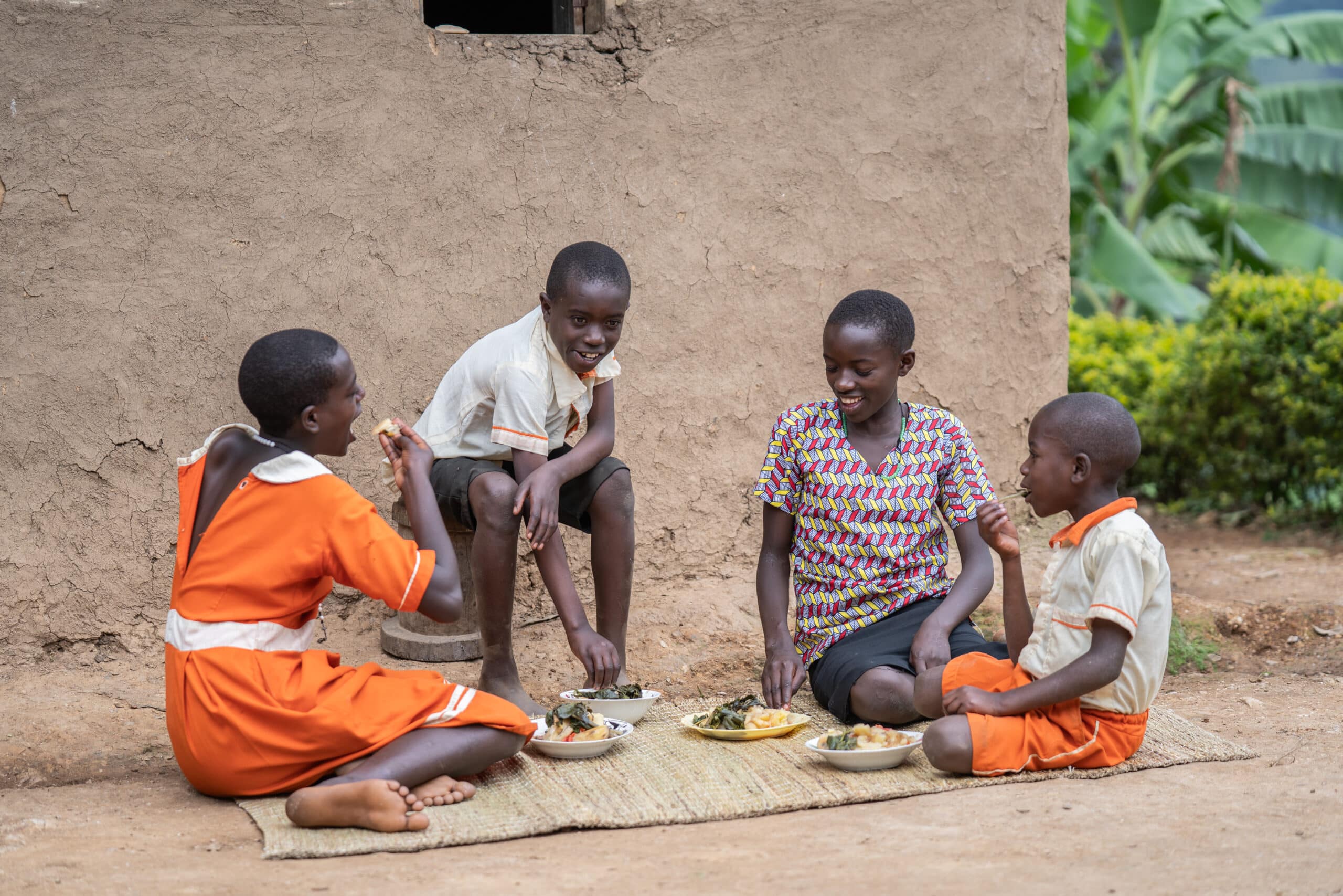 Scorah’s children enjoy a meal with vegetables after returning home from school.